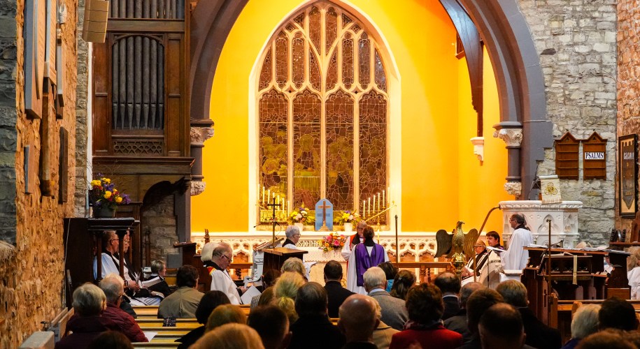 Interior of St. Patrick's Cathedral, Trim, with golden lighting and ornate window during the Institution and Installation service
