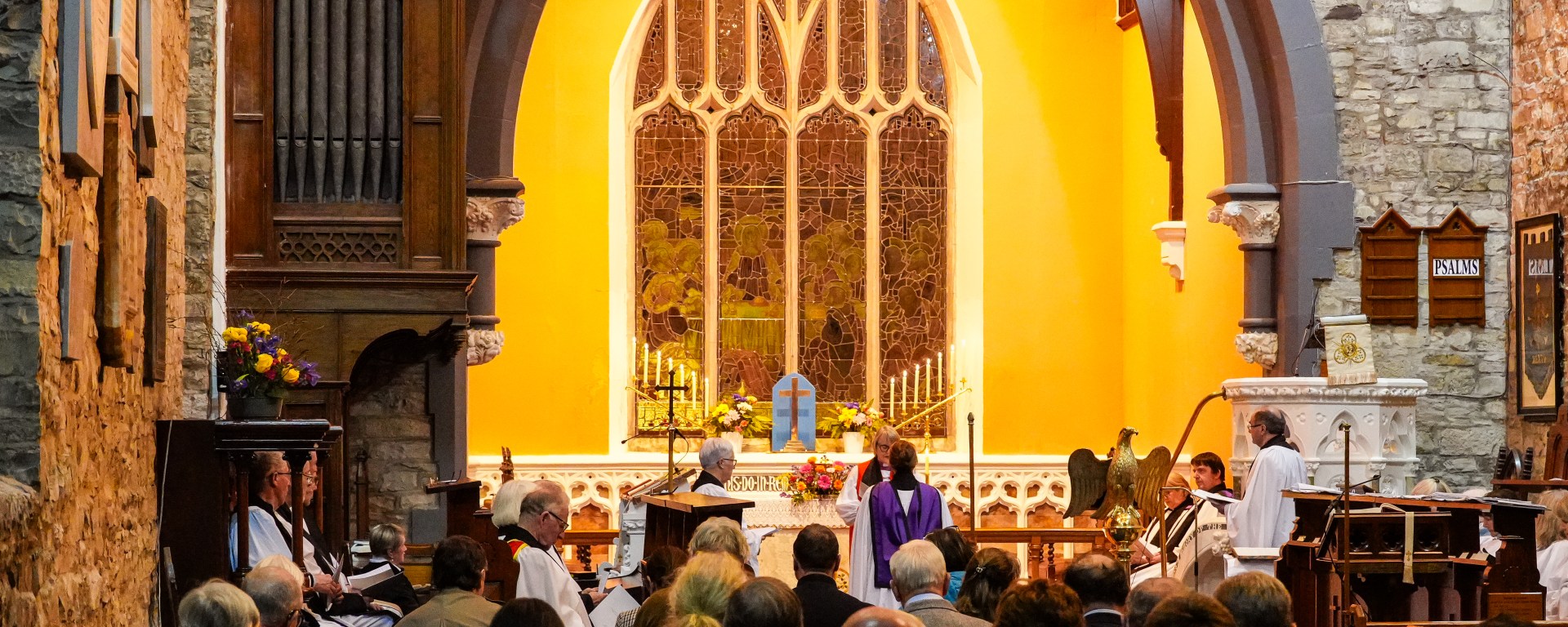 Interior of St. Patrick's Cathedral, Trim, with golden lighting and ornate window during the Institution and Installation service